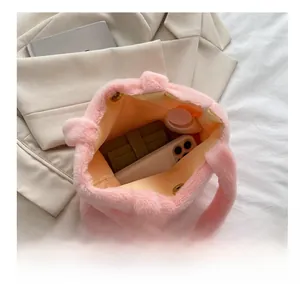 Top view of pink plush handbag interior showing spacious capacity and magnetic snap closure