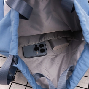 Detail view of large capacity gray nylon backpack interior with phone and power bank