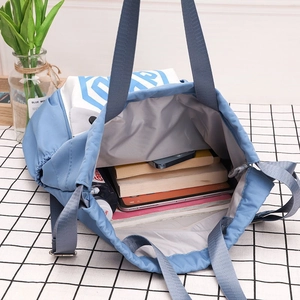 Interior view showing the large capacity of the blue nylon drawstring bucket backpack