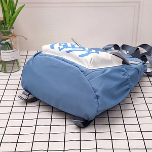Detail view of the durable nylon fabric and adjustable strap of this blue bucket backpack
