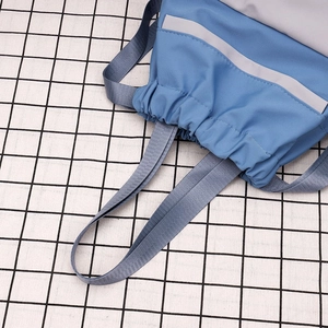 Detail of blue and grey nylon drawstring bucket bag with reflective safety strip