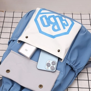 Detail view of contrast nylon drawstring backpack showing interior capacity with phone