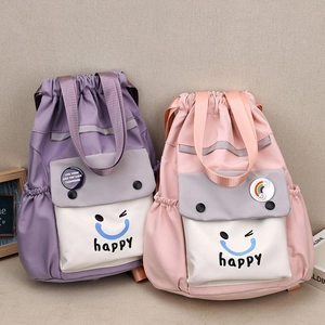 Close-up of lightweight nylon bucket backpacks in pastel purple and pink with smiley prints