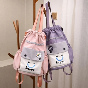 Detail of colorful nylon bucket backpacks with drawstring and happy face pocket