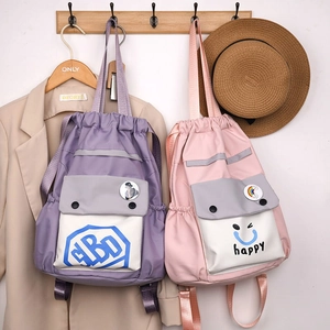 Close-up of lightweight nylon drawstring bucket bags in purple and pink with patch pockets