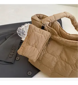 Close-up of khaki quilted tote bag featuring diamond stitching and detachable small pouch