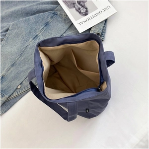 Detail view of large capacity dark blue canvas tote bag with inner pocket and zipper
