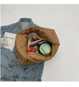 Detailed top view of a brown quilted tote bag showing its spacious internal capacity