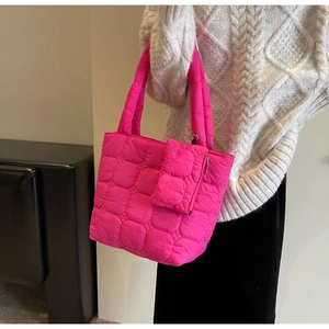 Detail of fuchsia quilted puffer tote bag with a matching detachable small pouch
