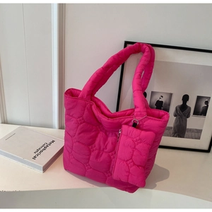 Detail of rose red quilted nylon tote bag with matching mini pouch and soft padded handles