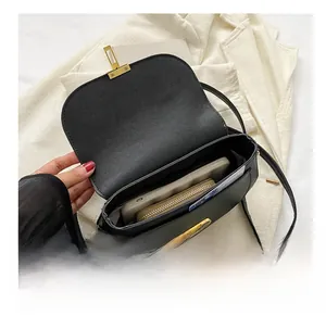 Detail showing internal capacity of the black pebble leather bag with gold twist lock