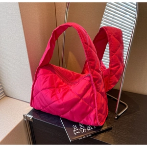 Detail of hot pink quilted puffer tote bag with classic rhombus pattern and zipper
