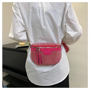 Detail of rose red leather waist bag featuring silver studs and round mini coin purse