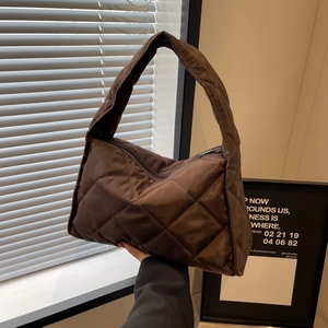 Deep brown quilted tote bag with diamond pattern and soft nylon texture shown in hand