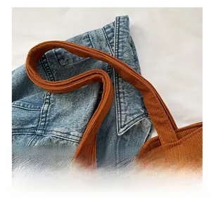 Detail shot of the thick brown corduroy shoulder strap and high-quality texture