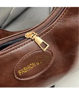 Detailed macro view of dark brown leather texture and golden metal zipper puller