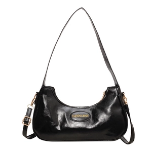 Black glossy crescent shoulder bag with golden hardware and pleated leather texture