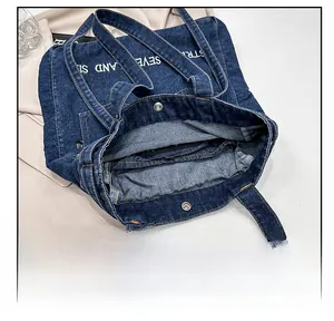 Detailed interior of the denim tote bag showing the magnetic snap and denim texture