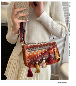 Detail view of Bohemian crossbody bag with colorful woven patterns and decorative tassels