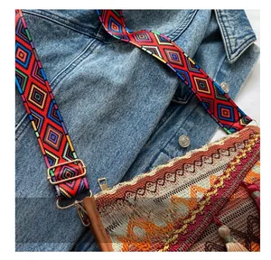 Close-up of bohemian shoulder bag with colorful geometric strap and metal buckle detail