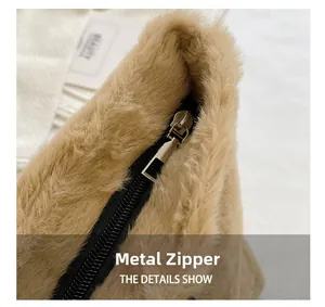 Detailansicht der khakifarbenen Webpelz-Textur mit einem stabilen silbernen Metall-Zipper