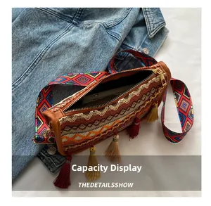 Ethnic crossbody bag with wide strap, colorful weaving and tassels showing storage capacity