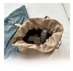 Macro shot showing large storage capacity of this khaki tote bag with daily essentials