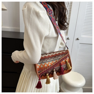Close-up of bohemian crossbody bag featuring ethnic patterns and colorful tassels