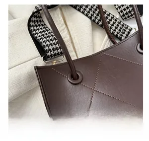 Détail du sac cabas en cuir matelassé marron foncé avec bandoulière en pied-de-poule