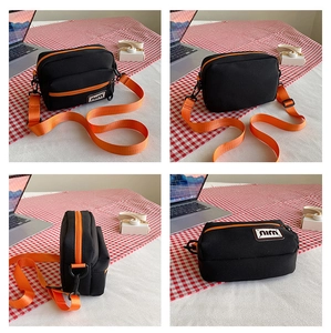 Detailed four-way views of a canvas crossbody bag with black body and orange straps