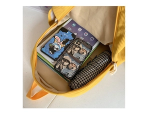 Detail view of spacious corduroy backpack interior holding a tablet and daily accessories