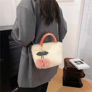 White plush shoulder bag with pink braided handle and cherry charm on a model