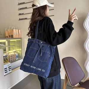 Fashionable large capacity denim tote bag for women with street art text and side pockets