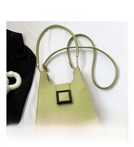Detail of avocado green litchi grain leather handbag with gold chain strap link