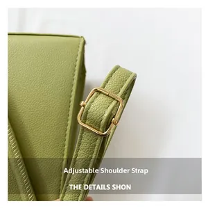 Detail of green lychee leather texture and adjustable golden metal square buckle