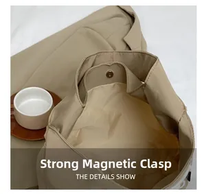 Detail showing the strong magnetic buckle closure of this canvas tote bag