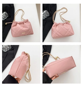 Pink quilted chain bag details showing stitching and golden adjustable ball buckle
