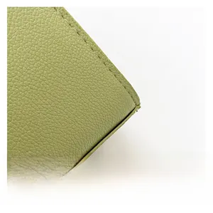 Detailed close-up of grass green lychee pattern leather showing high-quality stitching work