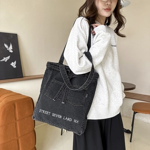 Washed black denim tote bag with street letters embroidery and double front pockets