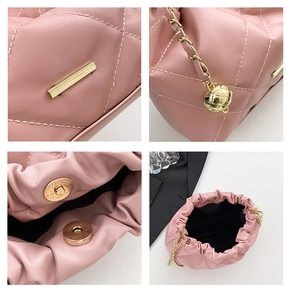 Detailed close-up of pink quilted crossbody bag with gold chain and magnetic buckle closure