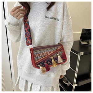 Close-up of Bohemian crossbody bag with colorful embroidery and long fringe tassels