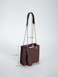 Detail view of burgundy quilted crossbody bag with gold chain strap and dimensions