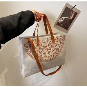 Detail of bohemian canvas tote featuring brown geometric mandala pattern and leather straps
