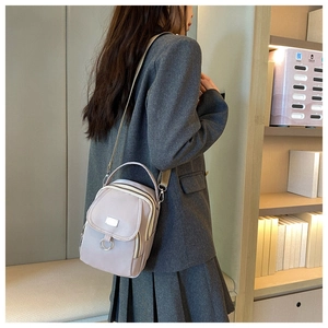 Close-up of lavender oxford fabric mini crossbody bag with silver hardware and woven strap