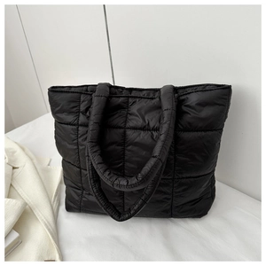 Detailed view of the black quilted puffer tote bag featuring durable nylon fabric textures