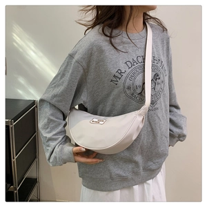 Close-up of the stylish crescent-shaped nylon crossbody bag in creamy white with logo detail