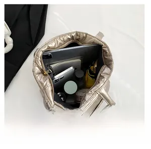 Top view of champagne gold quilted tote bag showing large interior storage capacity