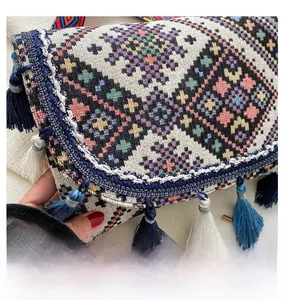 Detailed embroidery and blue tassel fringe on a boho ethnic style crossbody bag