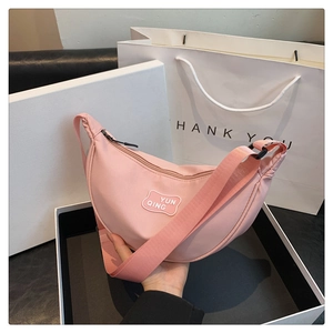 Pink crescent crossbody bag in a gift box with a matching thank you carrier bag