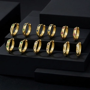 French style gold hoop earrings set with colorful zircon stones on black pedestals